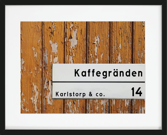 Personlig tavla med gatuskylt på gul vägg